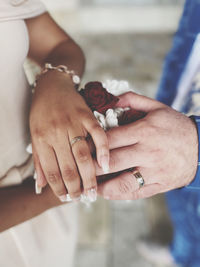 Midsection of couple holding hands