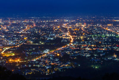 High angle view of illuminated buildings in city at night