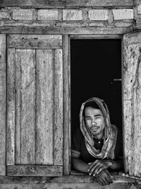 Portrait of girl sitting on window