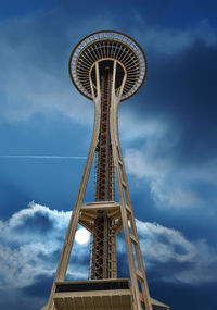 Low angle view of ferris wheel against cloudy sky