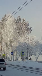 Information sign on street against sky during winter