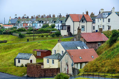 Houses in city against clear sky