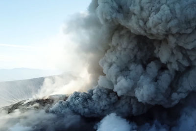 Smoke emitting from volcanic mountain against sky