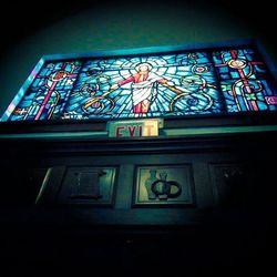 Low angle view of illuminated text on building wall