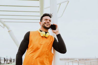 Man talking on smart phone at gym