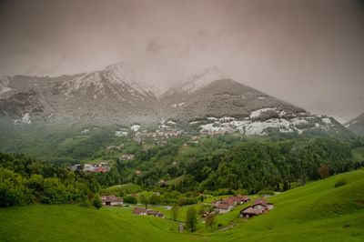 Scenic view of trees and mountains against sky