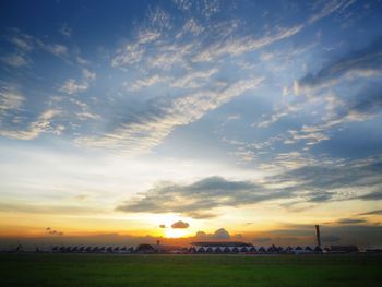 Scenic view of field against sky during sunset