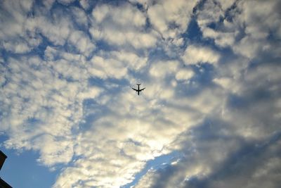 Low angle view of airplane flying in sky