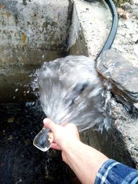 High angle view of human hand holding water