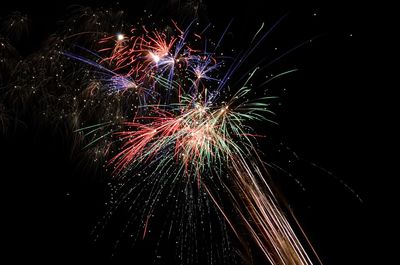 Low angle view of firework display at night