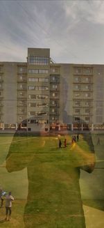 People in front of building against sky