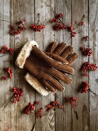 Directly above shot of red berries with gloves on table