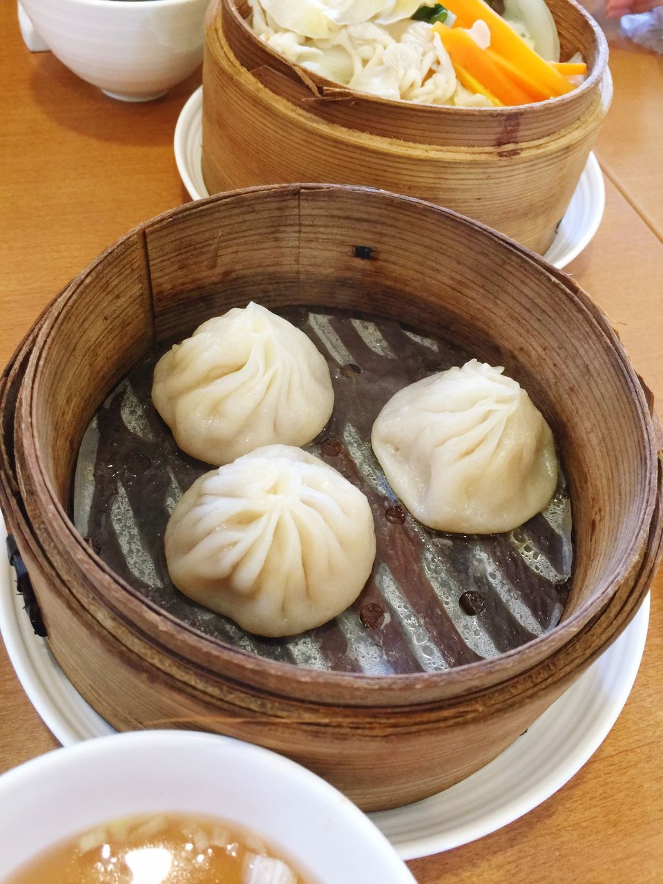 food and drink, food, indoors, freshness, chinese dumpling, chinese food, still life, close-up, culture, bowl, group of objects, in a row, dim sum, high angle view, temptation, plate, meal, indulgence, appetizer, dumpling, large group of objects, tray, choice, order, dish, arrangement