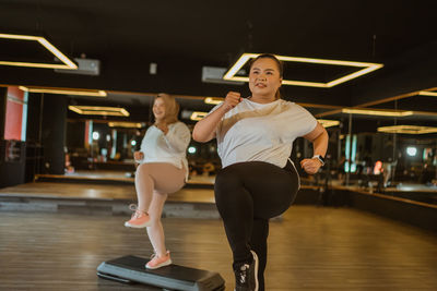 Portrait of young woman exercising in gym