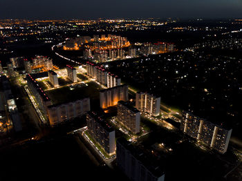 High angle view of illuminated buildings in city at night