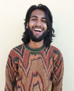 Portrait of smiling young man against white background