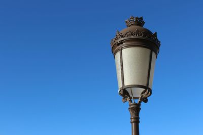 Low angle view of street light against clear blue sky