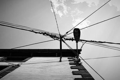 Power lines cables connected on building wall