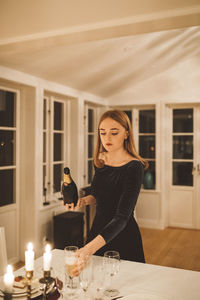 Young woman pouring champagne