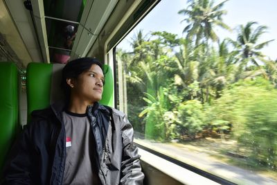 Man looking through train window