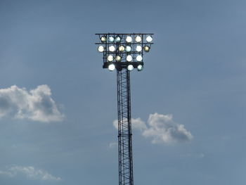 Low angle view of electricity pylon against blue sky