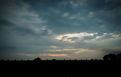 Silhouette of landscape against cloudy sky