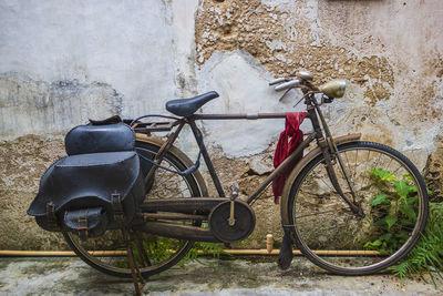 Vintage bicycle parked in front of the old wall in the old town area, phuket, thailand.