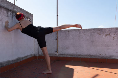 Woman stretching out on a terrace warming up