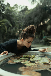 Young woman eating food on plant