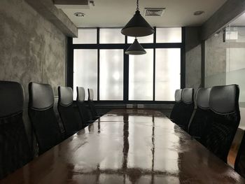 Empty chairs and tables in building