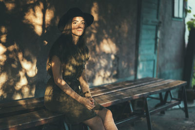 Portrait of smiling young woman sitting outdoors