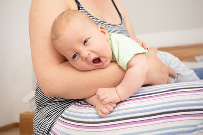 High angle view of baby boy lying on bed at home