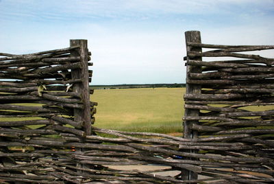 Old wooden fence on field