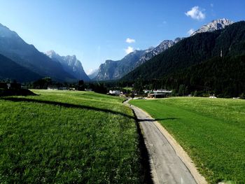 Scenic view of land and mountains against sky