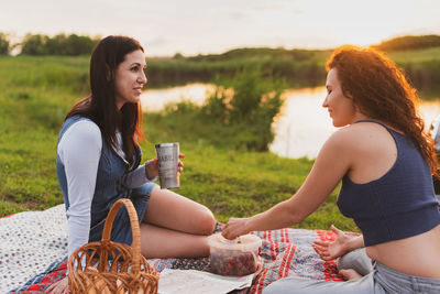 Young women sitting on land