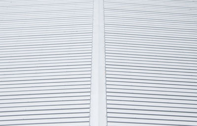 Perspective of the modern metal roof on the large warehouse in the industrial park.