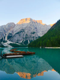 Scenic view of lake and mountains against clear sky