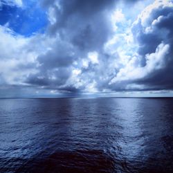 Scenic view of calm sea against cloudy sky