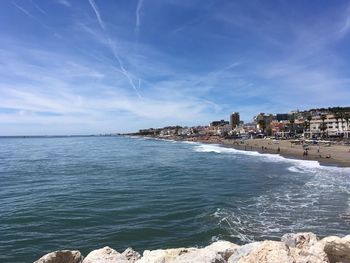 Scenic view of sea against sky in city