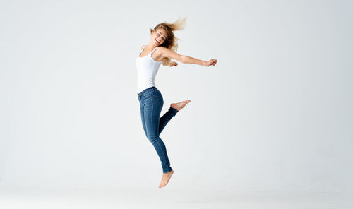 Woman jumping against white background