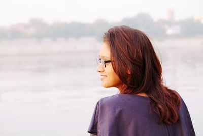 Rear view of woman against sea