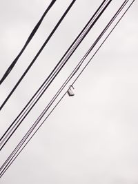 Low angle view of power lines against clear sky