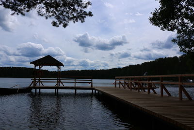 Scenic view of swimming pool by lake against sky