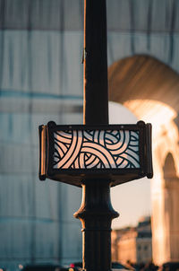 Close-up of illuminated electric lamp on wall