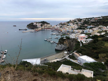 High angle view of townscape by sea against sky