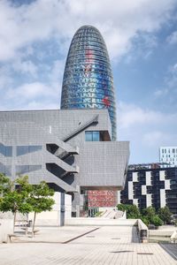 Modern office building against cloudy sky