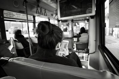 Rear view of people sitting in train