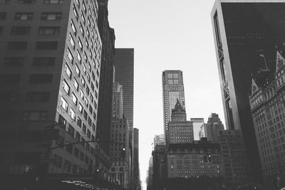 Low angle view of skyscrapers against clear sky