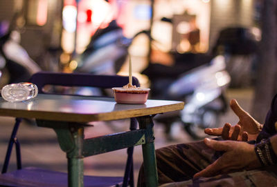 Midsection of man having food at restaurant table