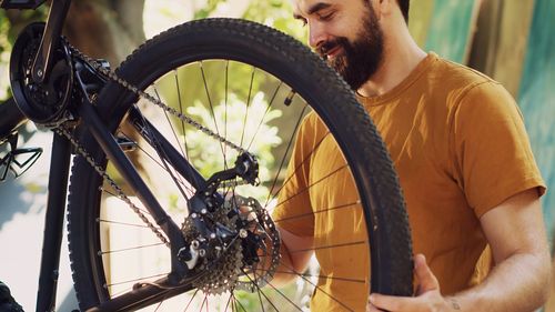 Midsection of man riding bicycle